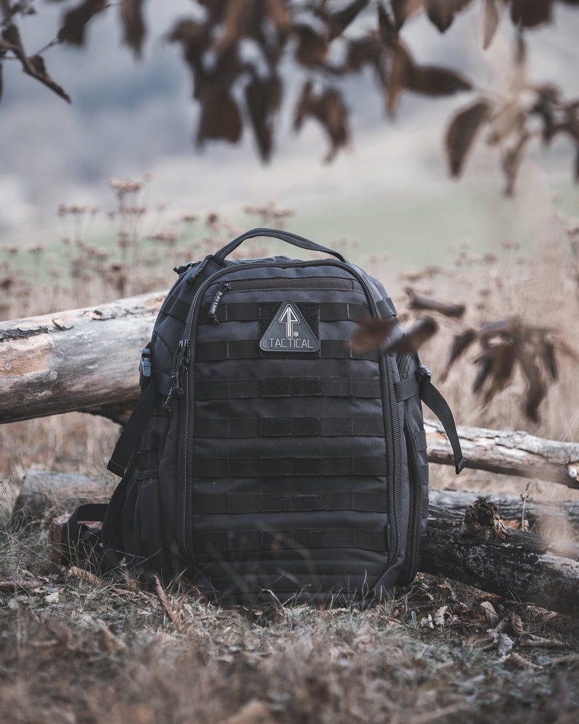 Durable tactical backpack positioned on the ground, poised for outdoor exploration