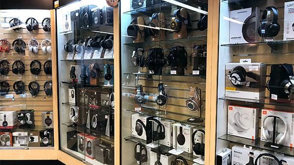 Photo of inside Audio46 showing glass cases full of headphones available for demo