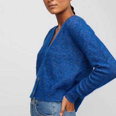 Close up of model syling cobalt blue V Neck cardigan sweater by Just Female