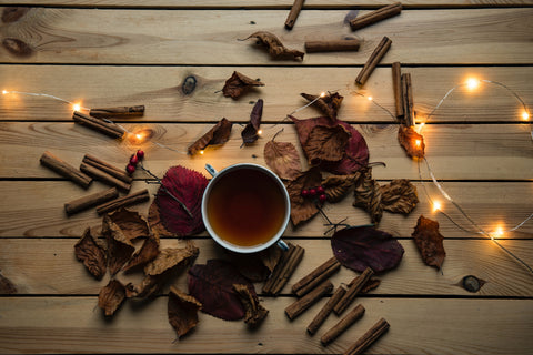 Coffee, cinnammon, leaves on wood backdrop