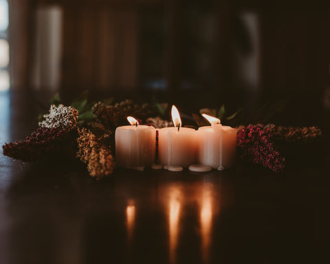 Lit candles in front of table garland