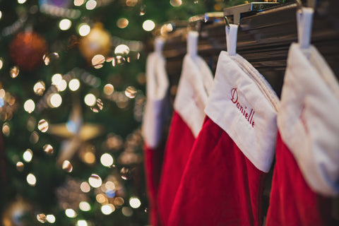 Red Christmas stockings hanging next to tree