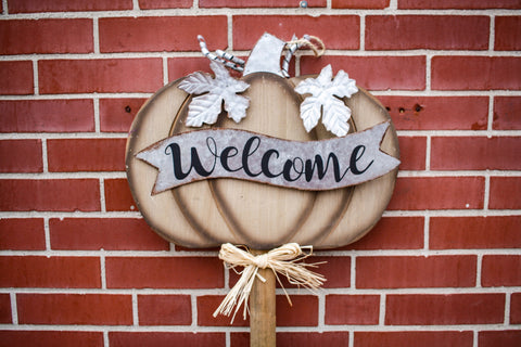 Pumpkin wood sign on brick wall