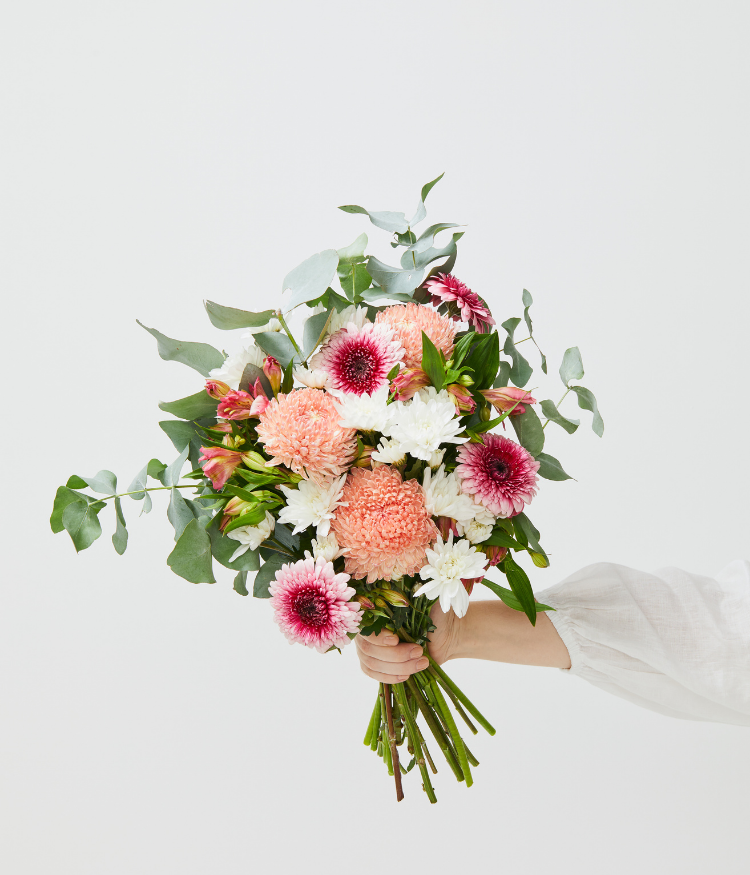 Send a Floraly Flower Subscription for Mother's Day. Image shows a handheld bouquet in pink, white and green tones.
