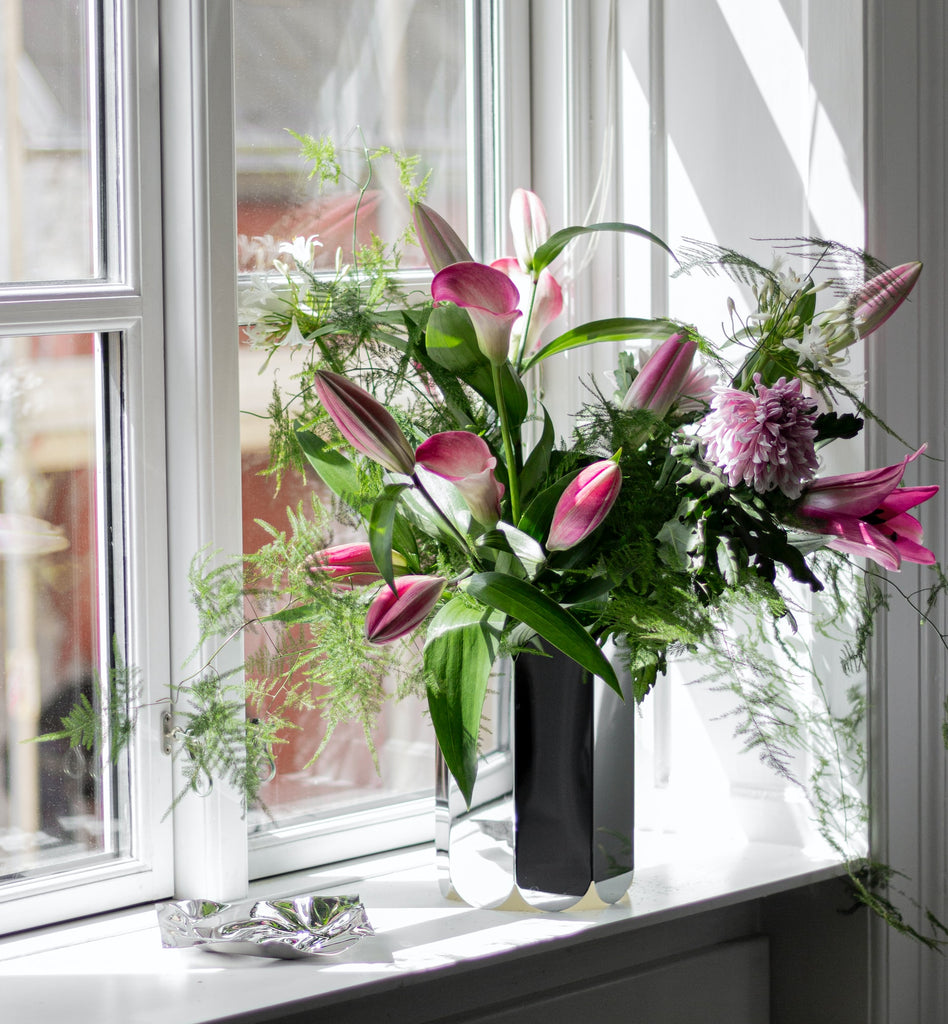 lilies in a bouquet on a windowsill