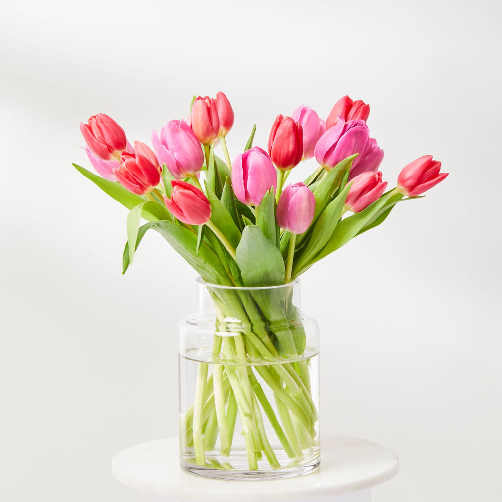 mixed pink and orange tulips in a glass vase