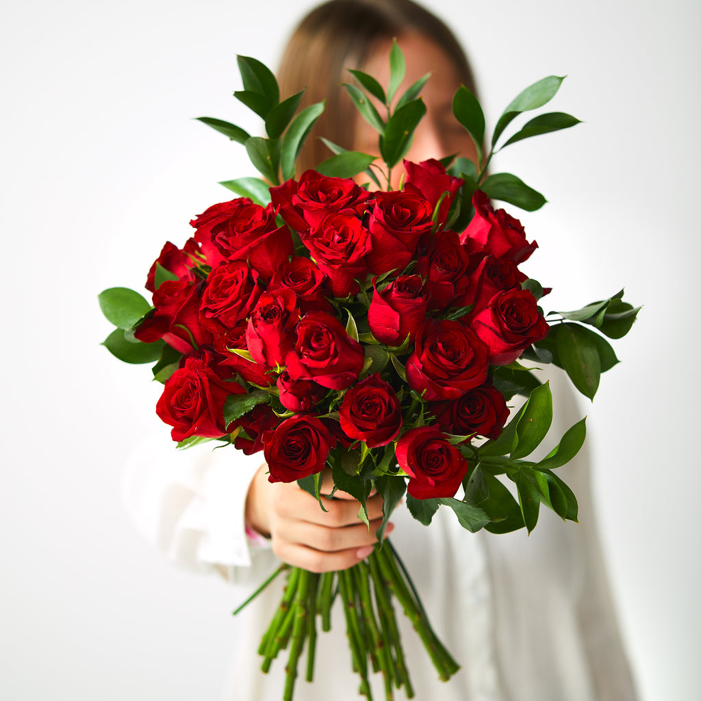 woman holding 30 red roses