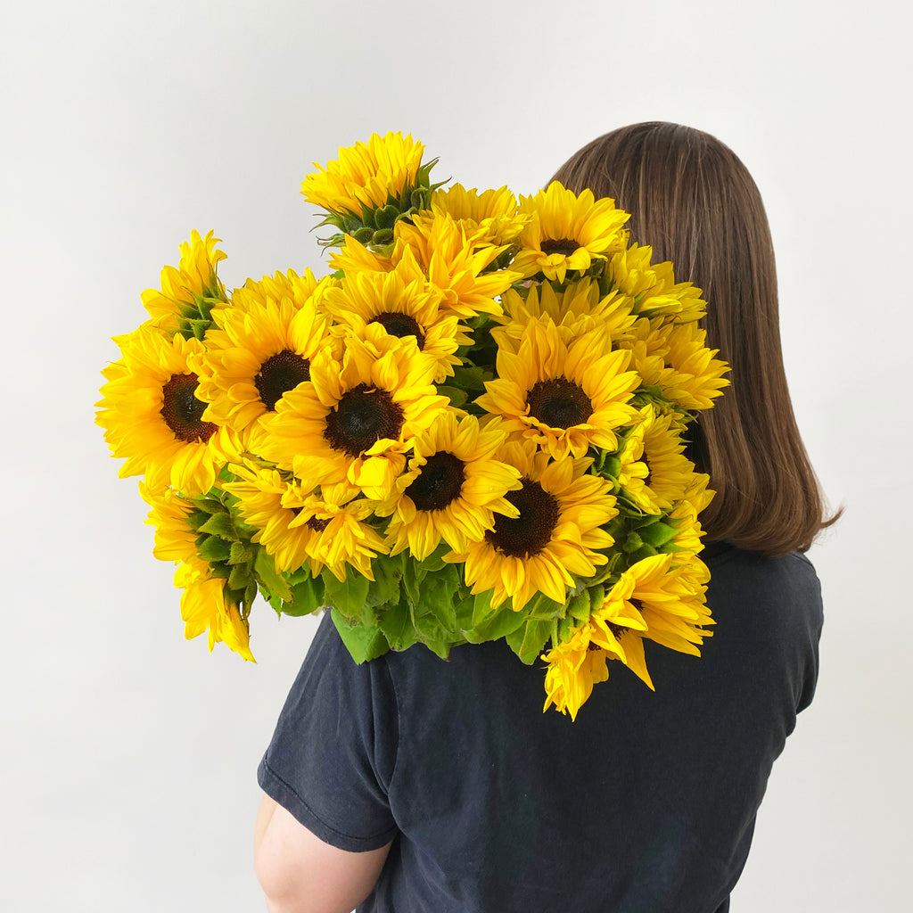 woman with sunflowers on her shoulder
