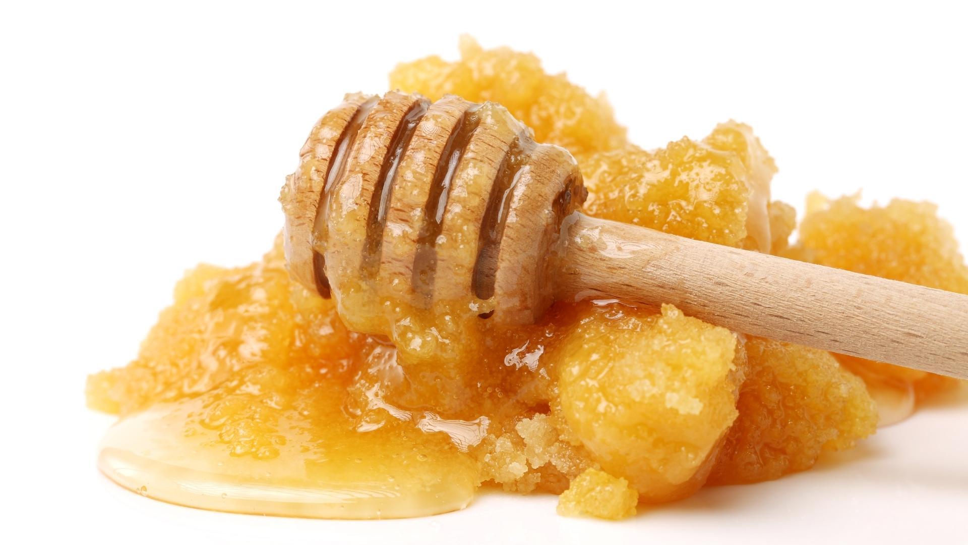 Astor Apiaries - Pile of crystalized honey with a dipper