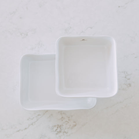 two white square ceramic serving dishes