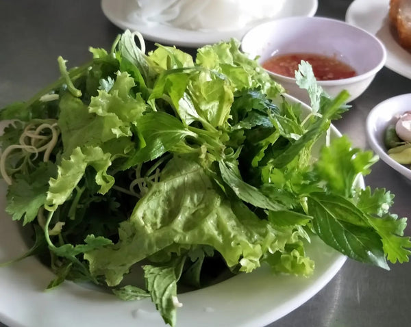 Fresh vegetables and dipping chilli sauce accompanying Bánh cuốn