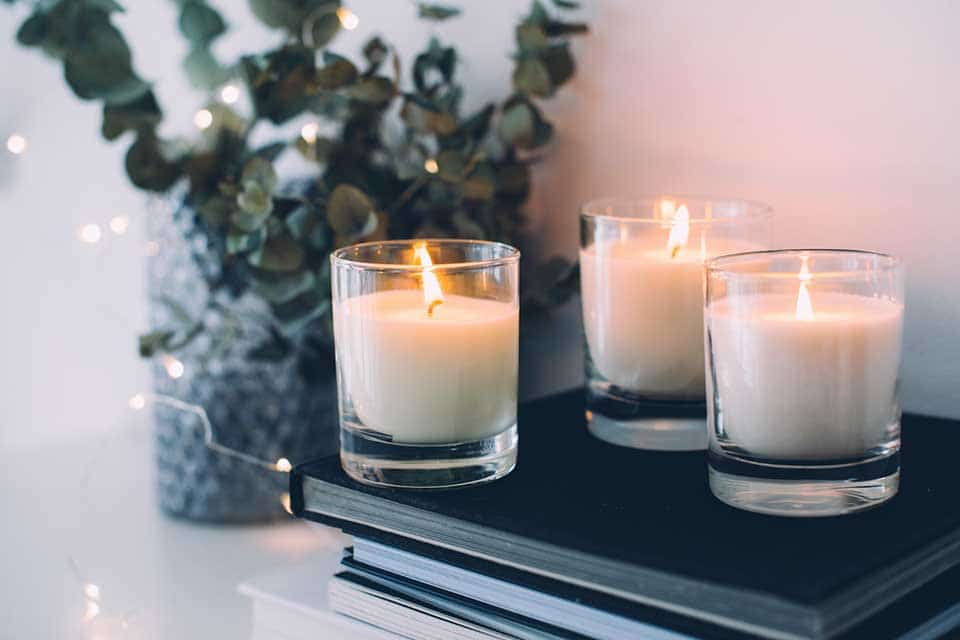 Three candles atop a stack of books