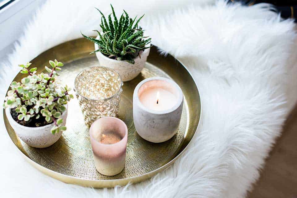 Candles on a tray resting on a white pillow
