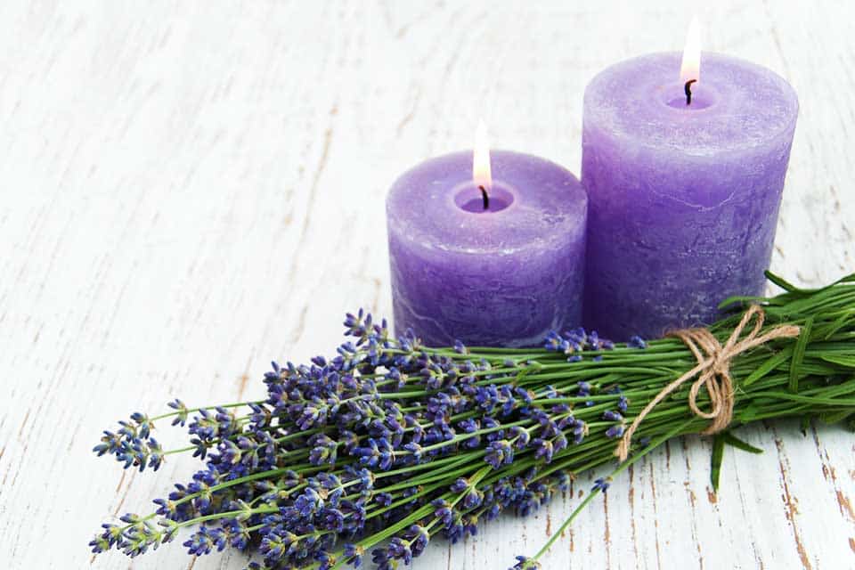 two lavender candles with wrapped lavender