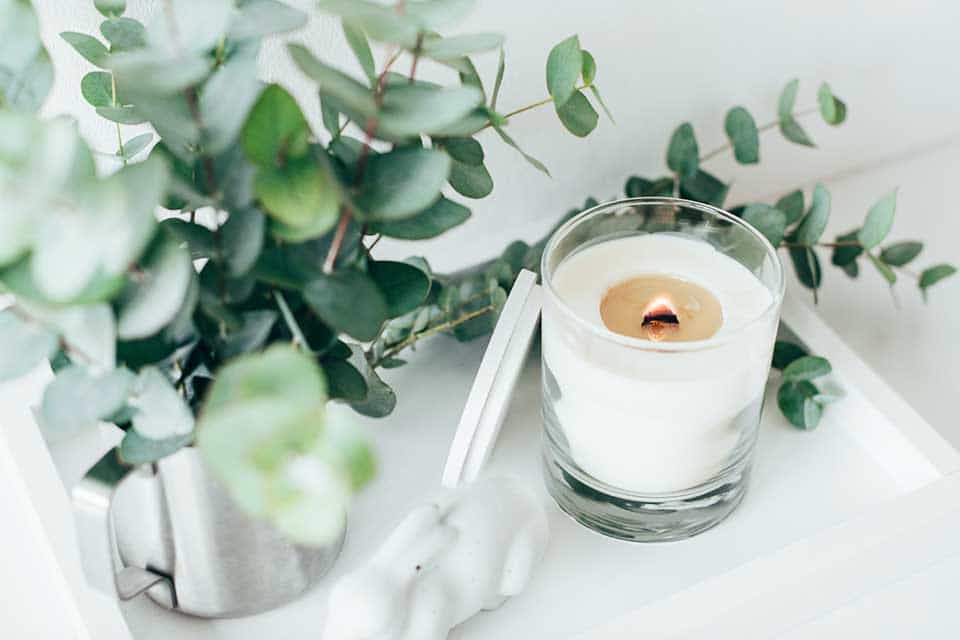Vanilla-scented candle on a tray