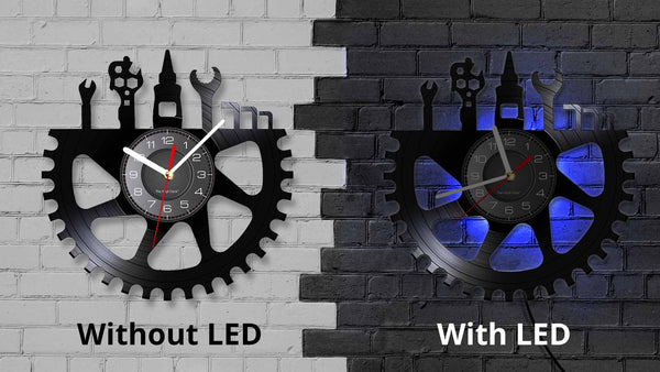 This unique vinyl clock features a bicycle tool design, crafted from recycled records. The clock is silent and has energy-efficient LED lighting with 7 color options, controlled by a remote. It's an ideal gift for bicycle enthusiasts and comes with a 30-day replacement policy.