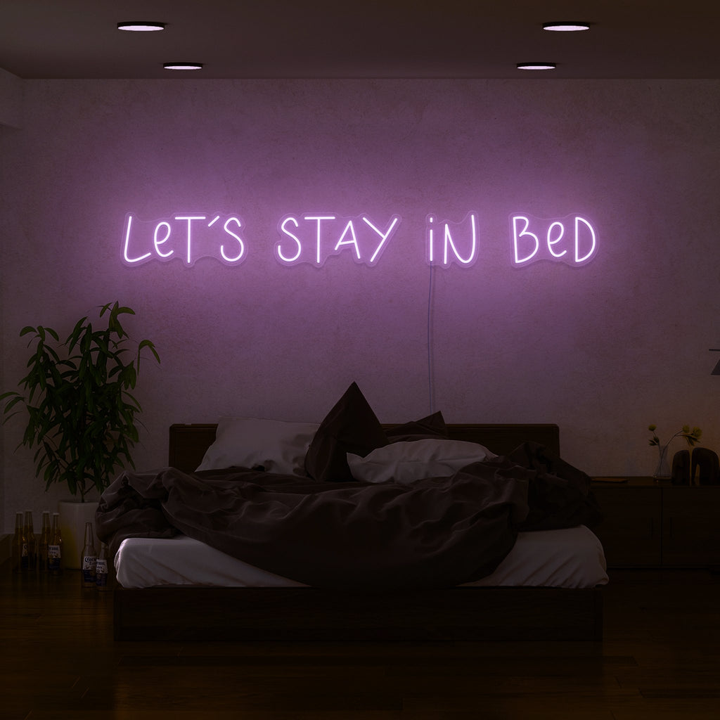 neon sign behind bed