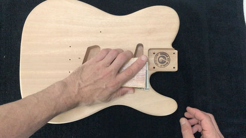 sanding the guitar