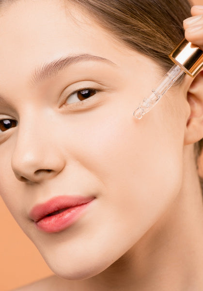 Woman applying face oil