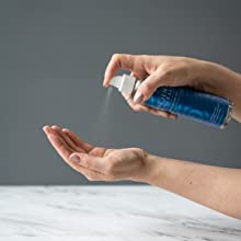 Applying Magnesium Oil Spray on the hand