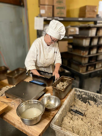 Gentry working with dough at Wild Leaven Bakery