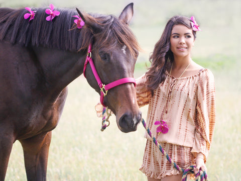 Local Hawaiian beauty Tania Dupont models Khush clothing and Fleurings jewelry. Pictured here with a large gold vase necklace and hairpieces with fresh pink vanda orchids. Photo by Studio 55 Boutique in Waimea on the Big Island of Hawaii. 