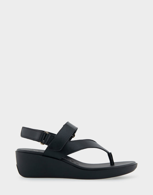 Black wedge sandals with crossed straps