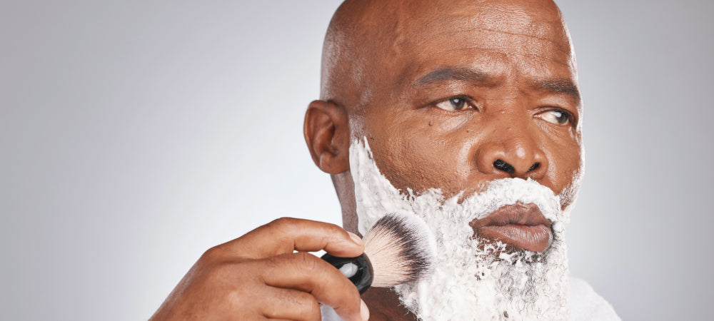 Man using shaving brush to apply lather