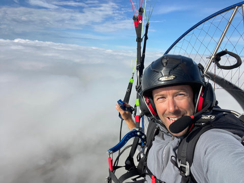 Alex paramotoring above the clouds
