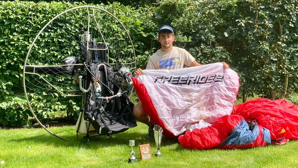 Man with paramotor and trophies