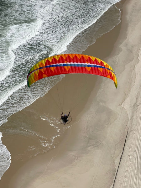 paramotoring over a beach in brazil