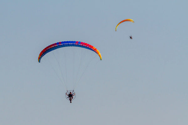 Two men flying paramotors