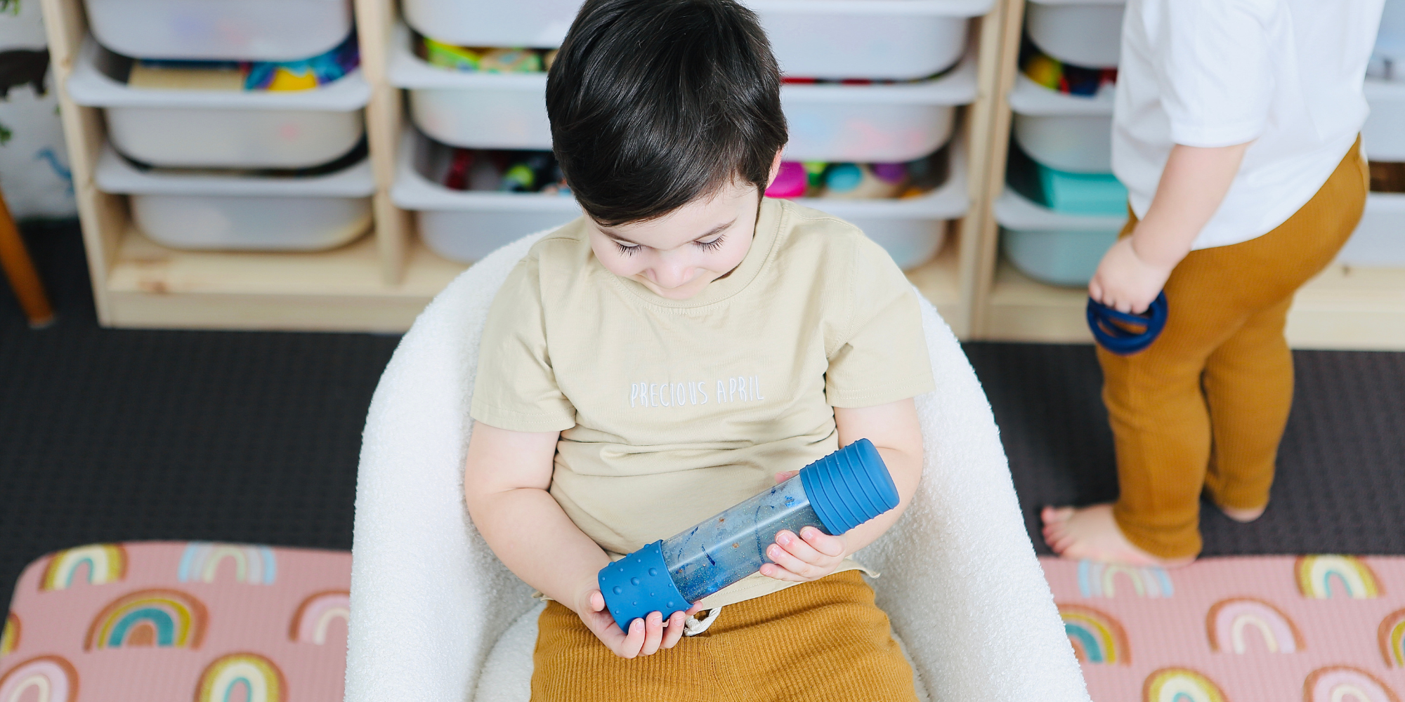 Boy playing with sensory bottle