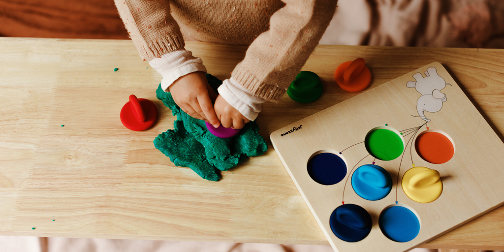 Child stamping silicone tops into playdough