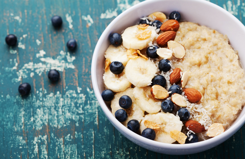 Bowl of oats, banana, almonds and sliced banana.