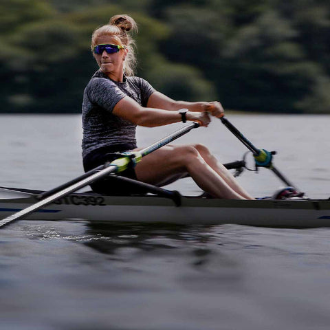 Girl rowing on lake.