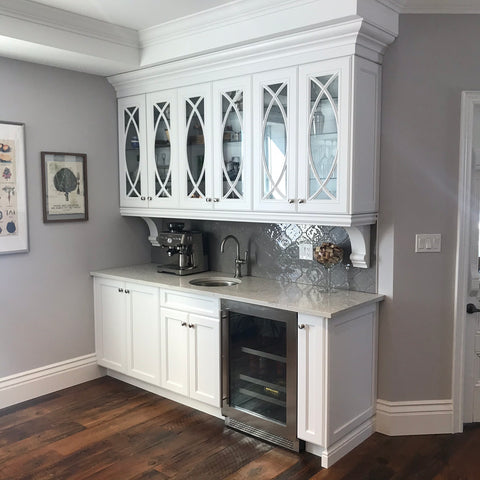 Kitchen bar area with sink, espresso machine, and bar fridge, glass cabinets