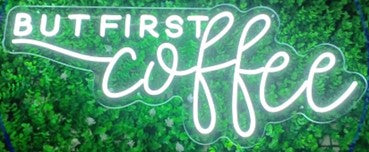 neon but first coffee sign with green background