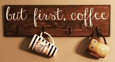 but first coffee sign with two coffee cups and brown wood in the back