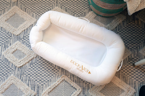 white dock a tot on floor on top of grey and white diamond patterned area rug. 