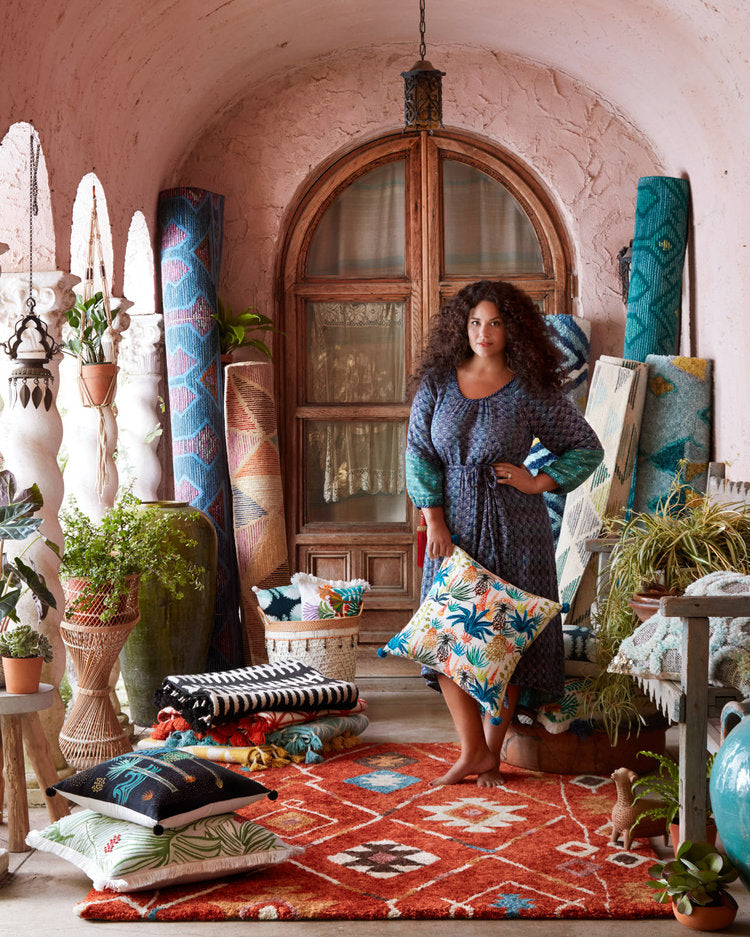 Justina Blakeney posing with rugs