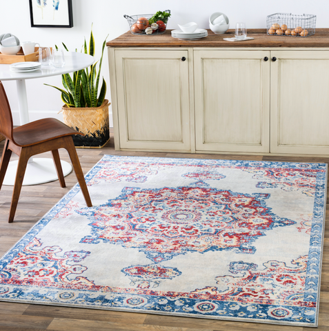 pink and blue rug with medallion in the center in a kitchen