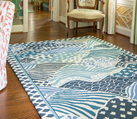 blue chinese inspired area rug in a french country living room