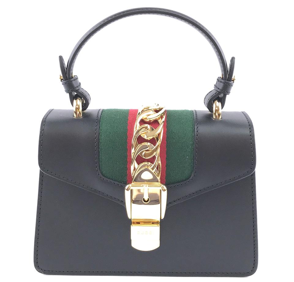 black gucci purse with green and red strap