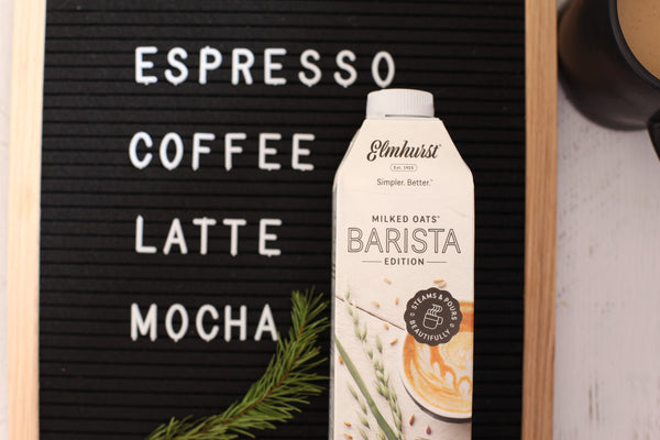 message board with the words espresso, coffee, latte and mocha with oat milk barista carton