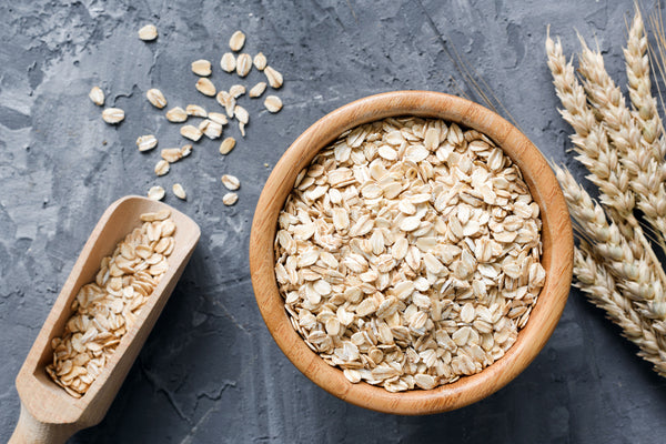 a bowl of whole grain oats with a scooper