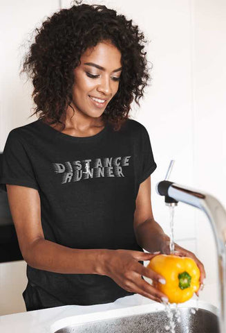 t-shirt of. happy woman washing a bell pepper