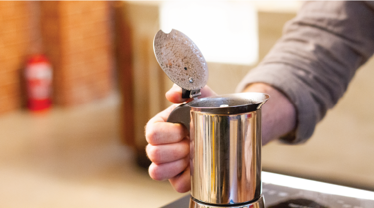 Opening top of stovetop coffee maker.