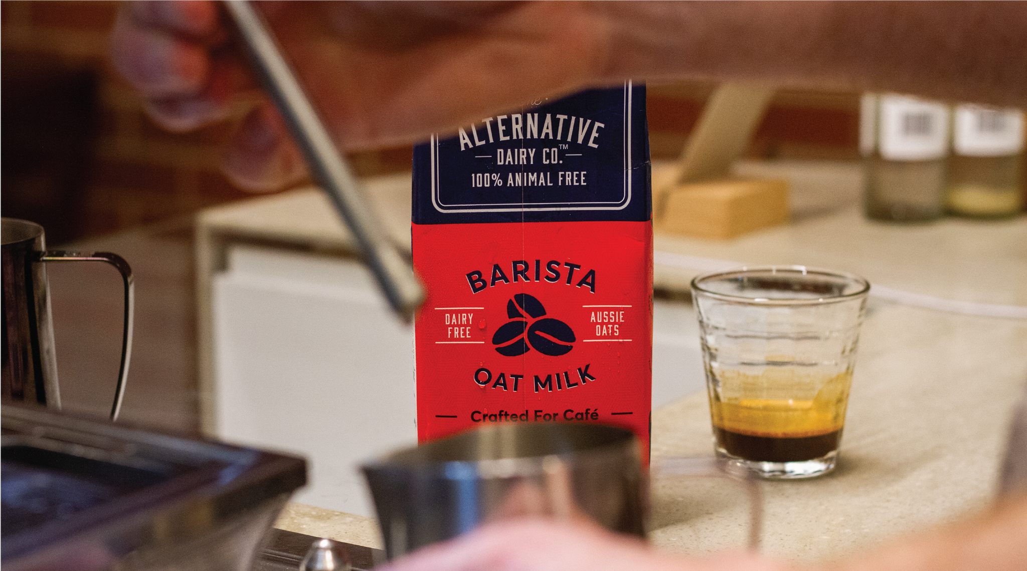 Image of Alternative Dairy Co Barista Oat Milk, alongside a shot of espresso