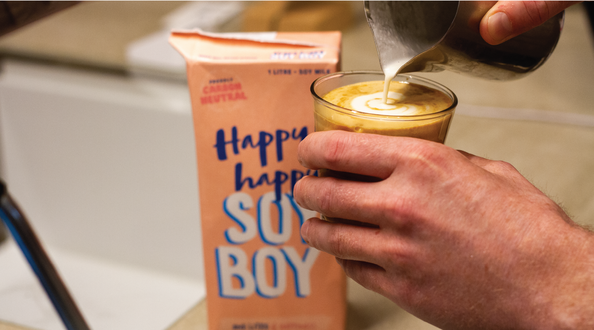 Pouring a latte with Happy Happy Soy boy soy milk at the Rumble Coffee Roasters espresso bar